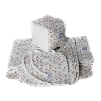 So Soft Organic Cotton Baby Accessories Package showing the contents of the package including a receiving blanket, diaper change pad, 2 burp pads, 3 sizes of bibs and a play/learning block